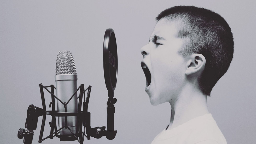 boy speaking into microphone